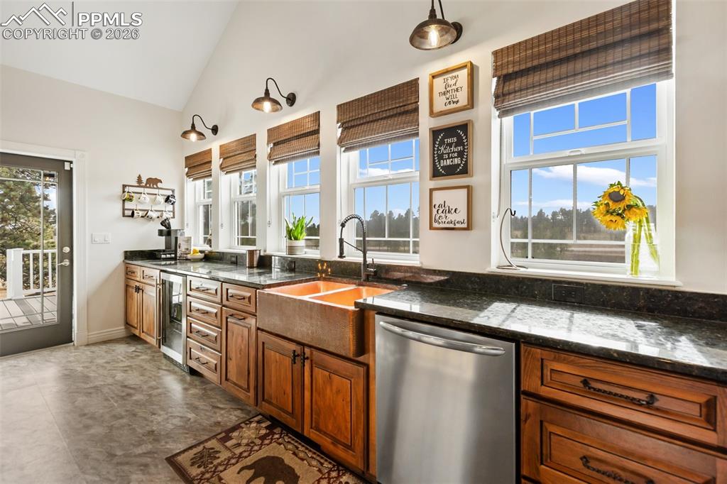 Image 16 of 50: Kitchen, copper sink, beautiful window views of the property