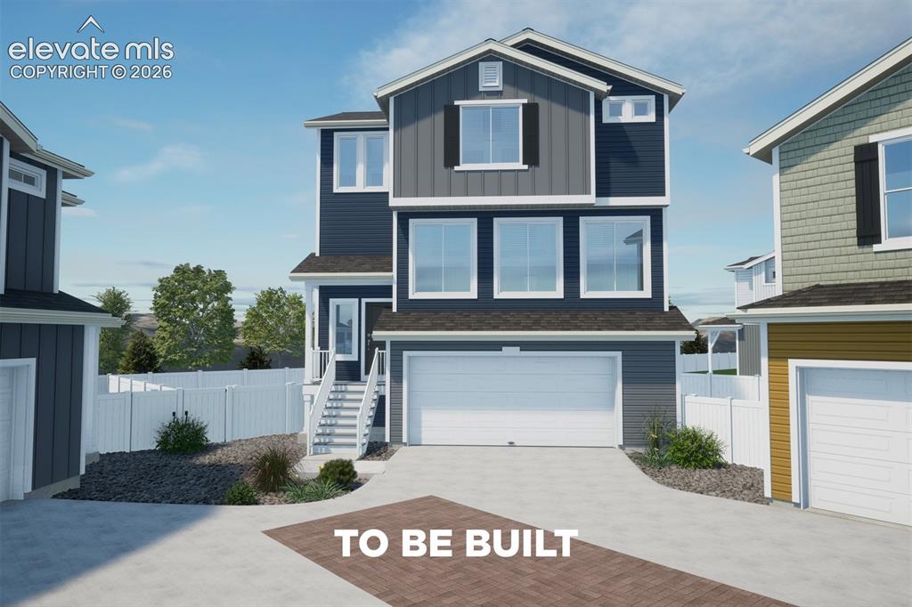 Caption: Three-story exterior with multi-toned siding, white trim, and a two-car garage