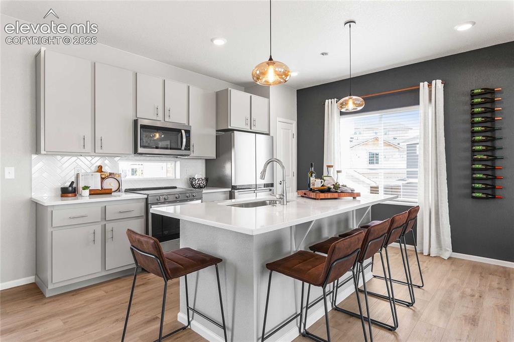 Image 12 of 31: Modern kitchen featuring soft-close cabinetry with brushed nickel hardware,