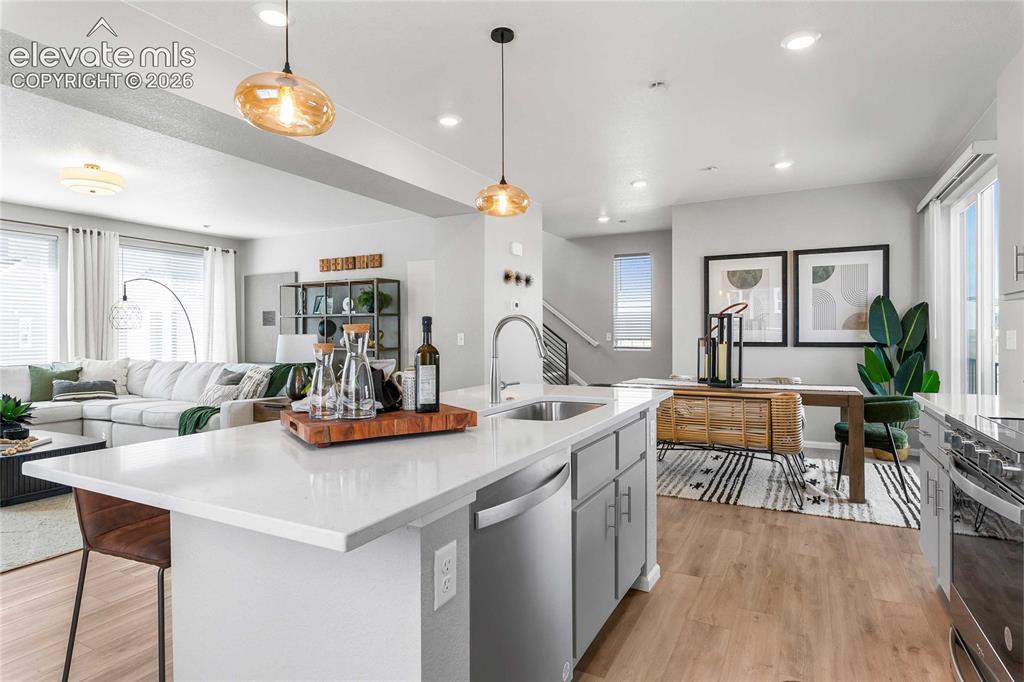 Image 14 of 31: Open-concept living space featuring wood-finish flooring, a kitchen island 