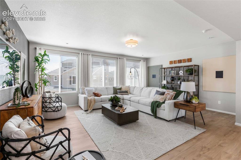 Image 17 of 31: Recessed lighting, wood-finish flooring, multiple windows with blinds, buil