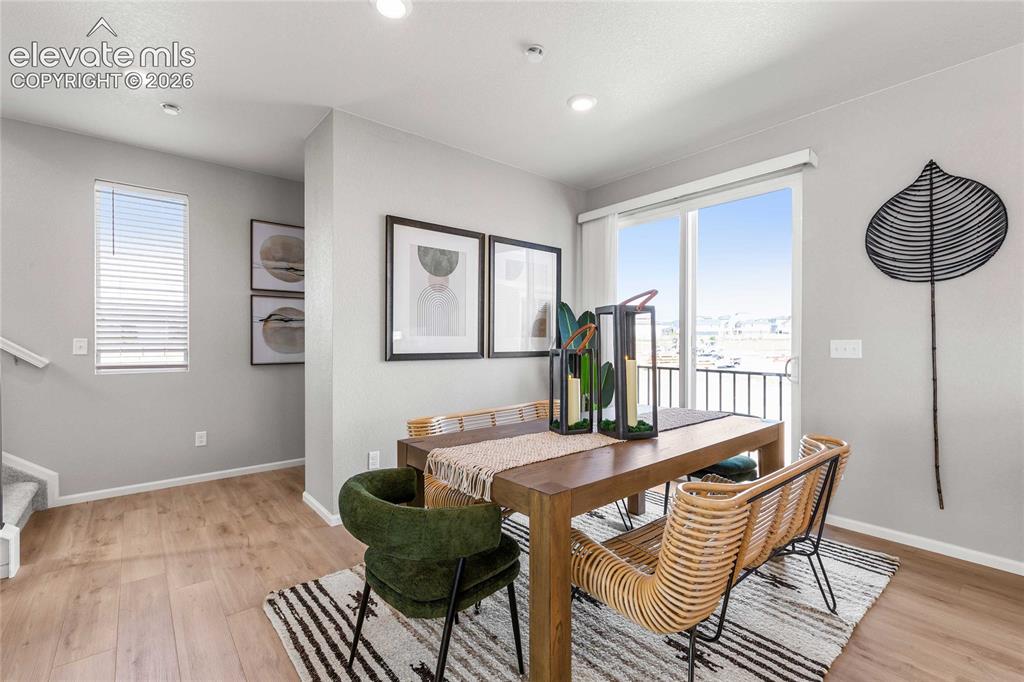 Image 2 of 31: Recessed lighting throughout, wood-finish flooring, sliding glass door with