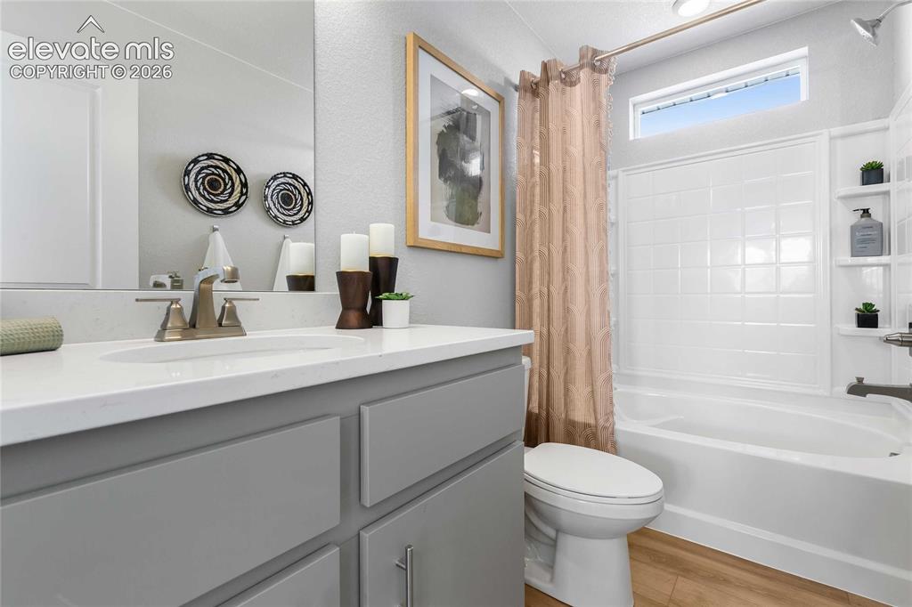 Image 26 of 31: Spa-inspired bathroom featuring a gray vanity with dual sinks, white quartz