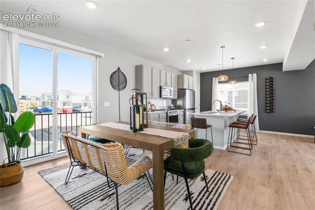 Image 3 of 31: Open-concept living space featuring wood-finish flooring, recessed lighting