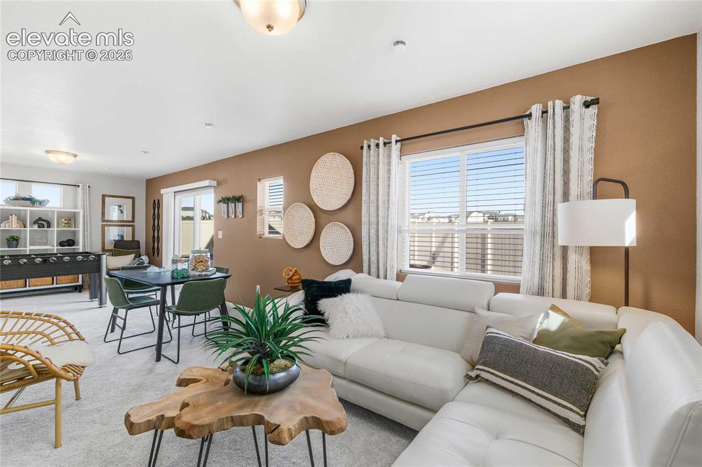 Image 5 of 31: Recessed lighting, large windows with blinds, sliding glass door, and neutr