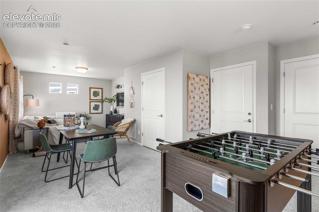 Image 7 of 31: Carpeted interior space with multiple white interior doors and recessed lig