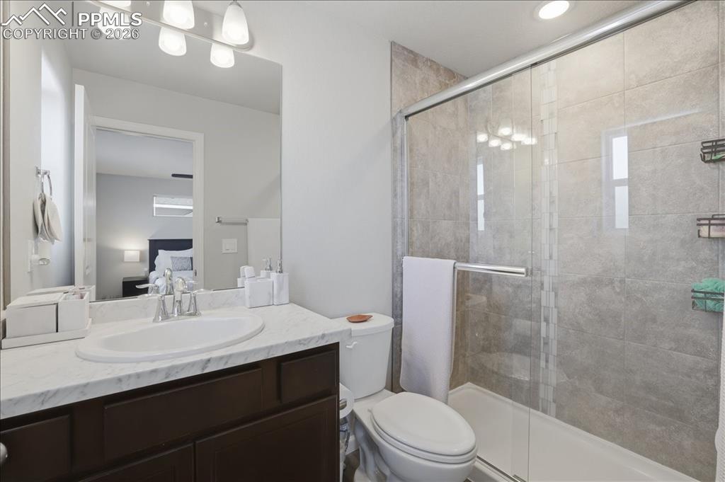 Image 23 of 47: Bathroom featuring a vanity with a white countertop and dark cabinetry, a t