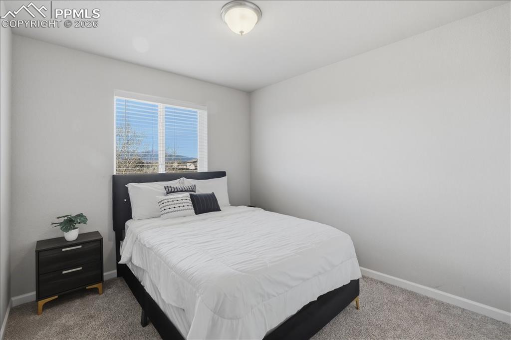 Image 24 of 47: Bedroom featuring light gray walls, carpet flooring, and a window with hori