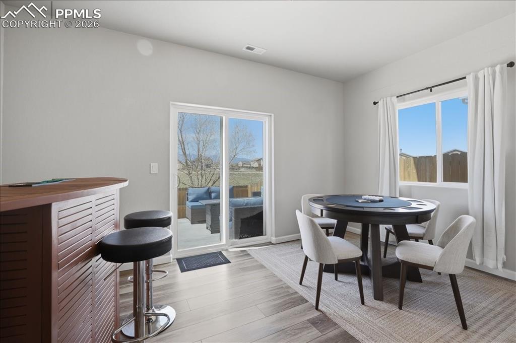 Image 29 of 47: This room features light-colored walls and wood-look flooring