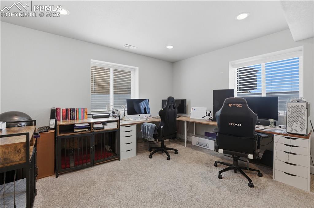 Image 31 of 47: This versatile room features carpeted flooring, recessed lighting, and two 