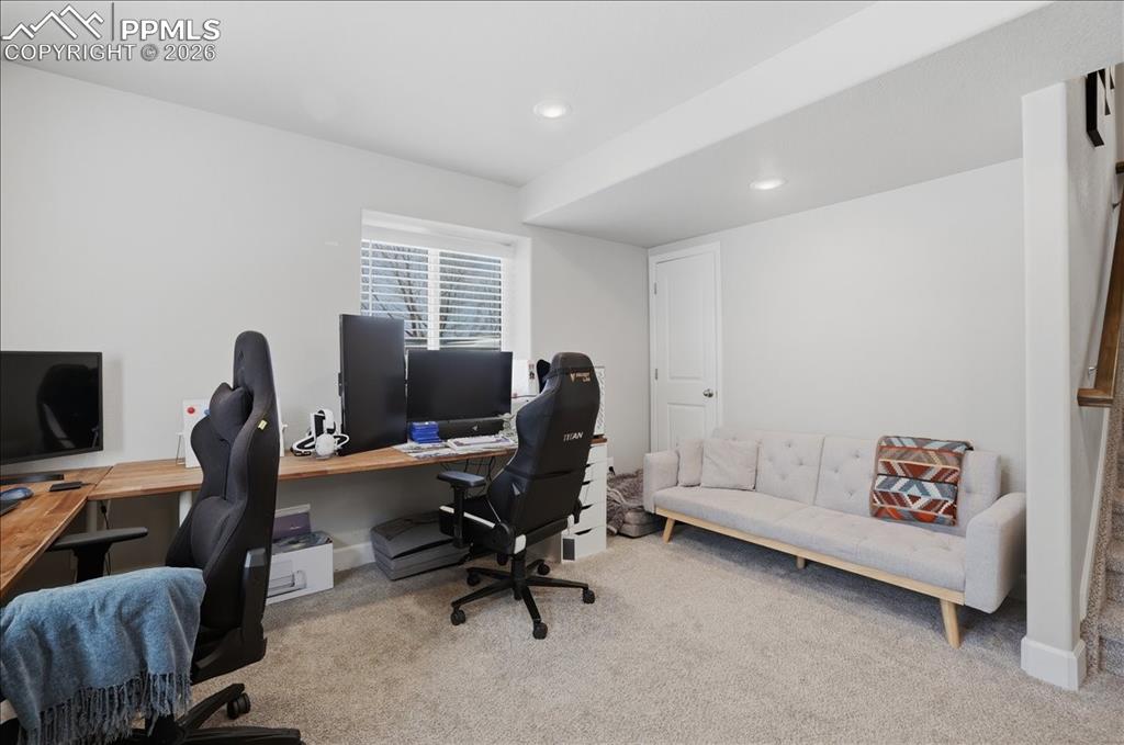 Image 32 of 47: This versatile room features light-colored walls, recessed lighting, and ca