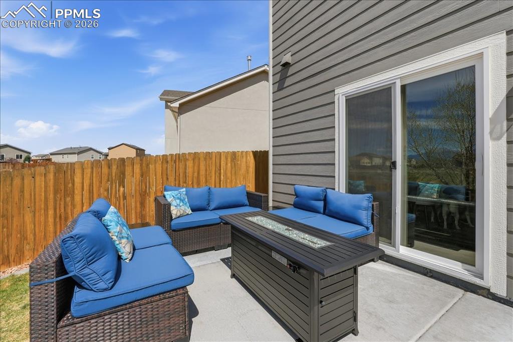 Image 42 of 47: The property features an outdoor patio area with a concrete surface, a slid