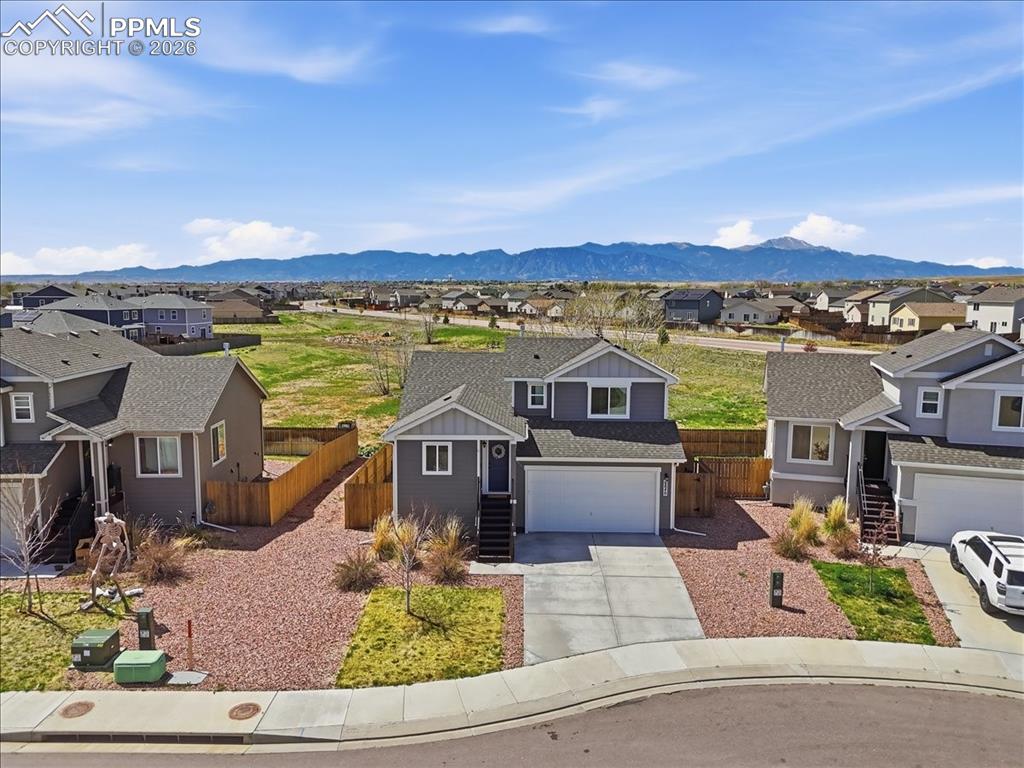Image 43 of 47: This property features a gray exterior with white trim, an attached garage,