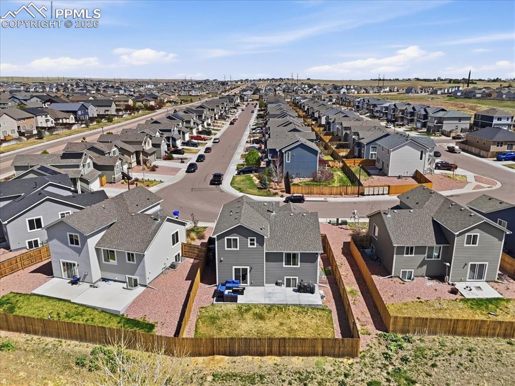 Image 46 of 47: The property features a spacious backyard with a concrete patio, a well-mai