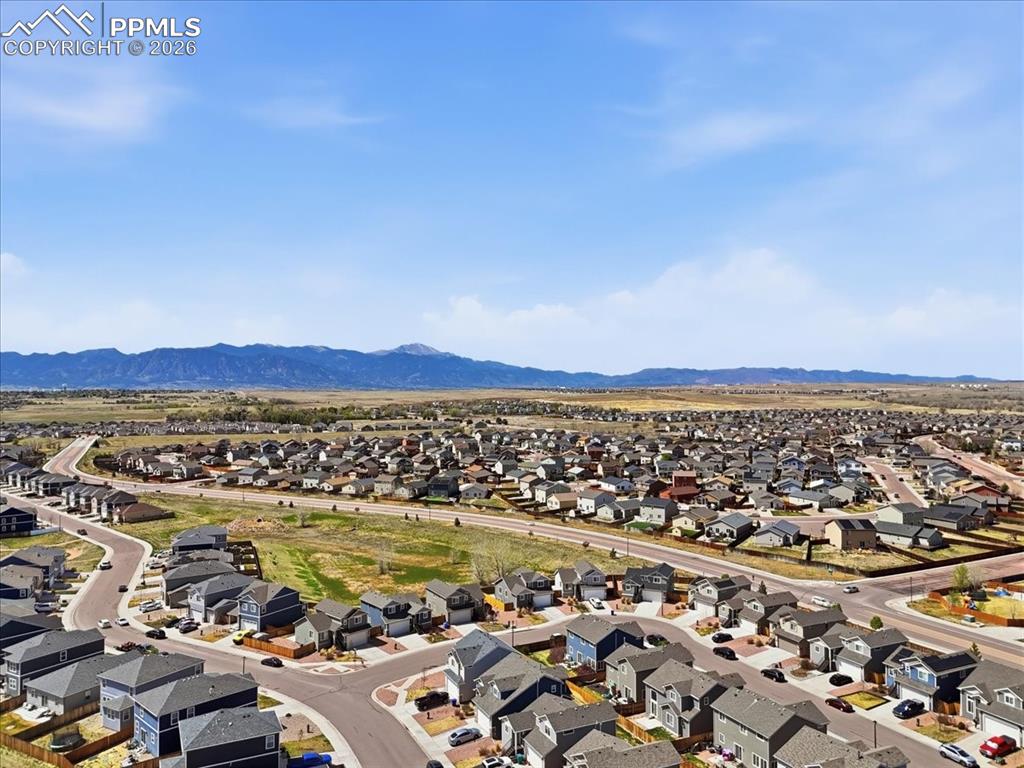 Image 47 of 47: Aerial view of the neighborhood showcasing a variety of homes, paved street