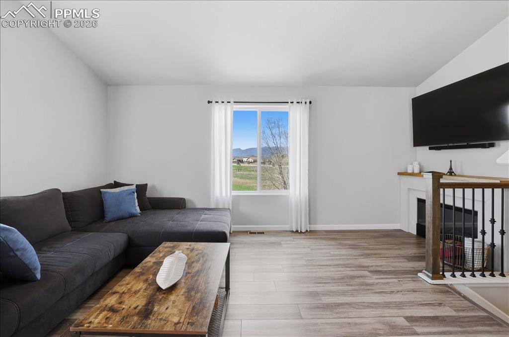 Image 7 of 47: Living area featuring light wood-style flooring, a window offering a view o