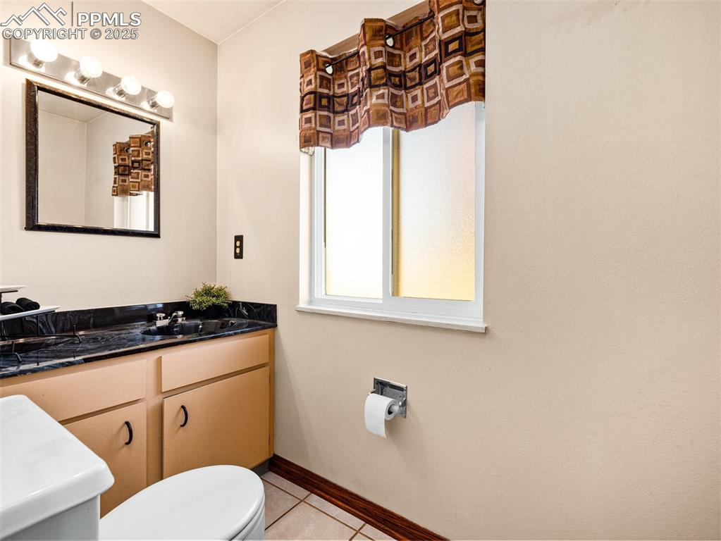 Image 11 of 38: Half bath featuring light tile patterned floors and vanity