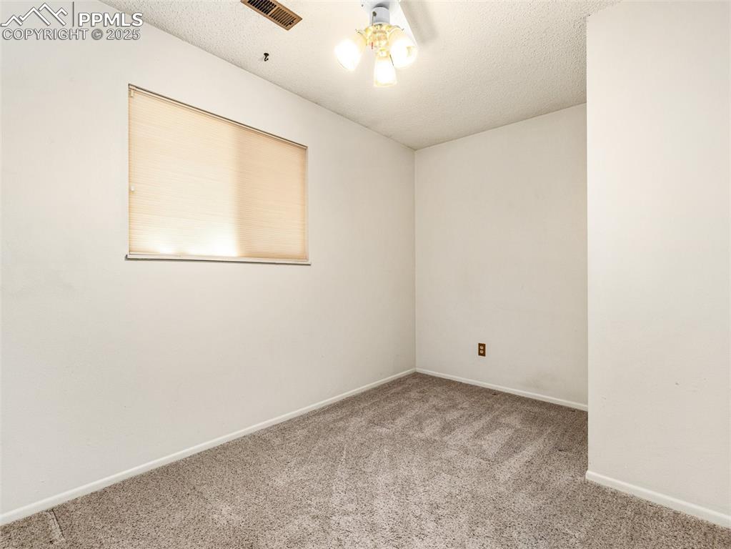 Image 18 of 38: Carpeted spare room with a textured ceiling
