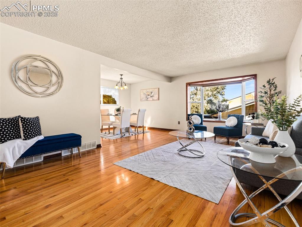 Image 2 of 38: Living room with wood finished floors, healthy amount of natural light, a t