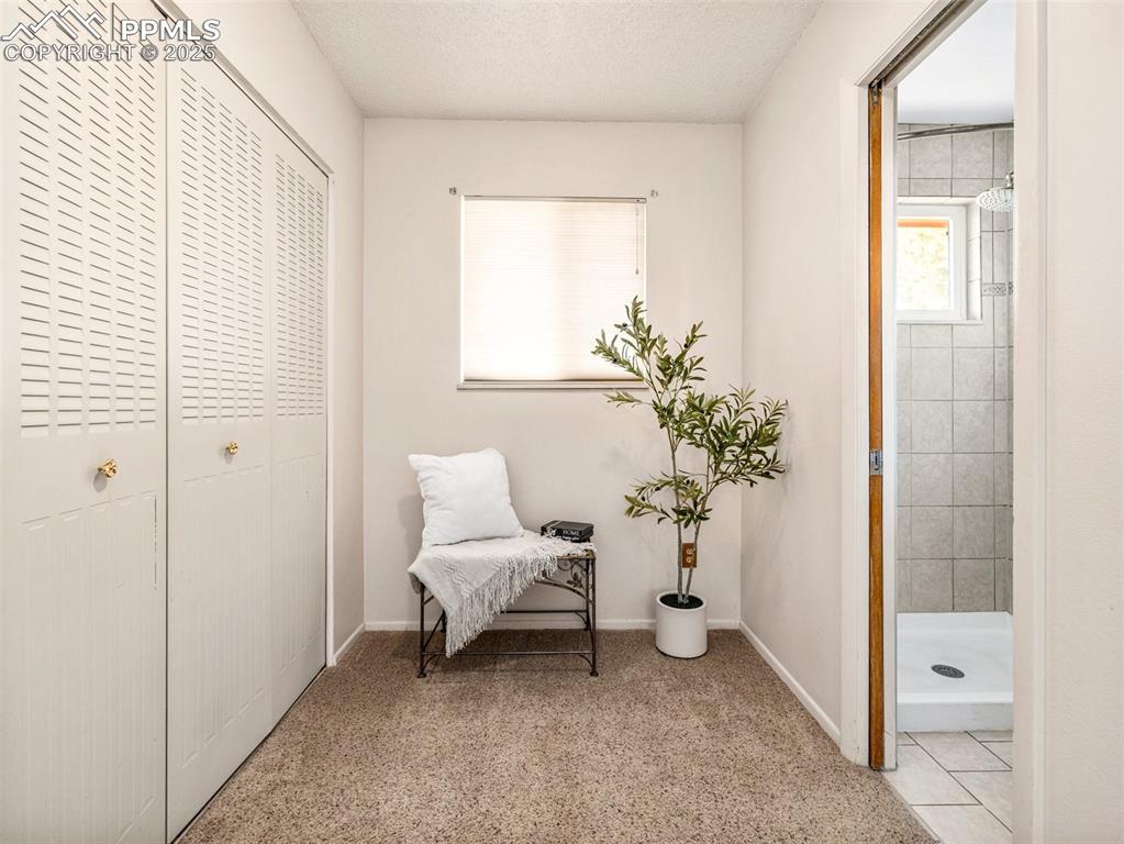 Image 23 of 38: Sitting room with baseboards and a textured ceiling