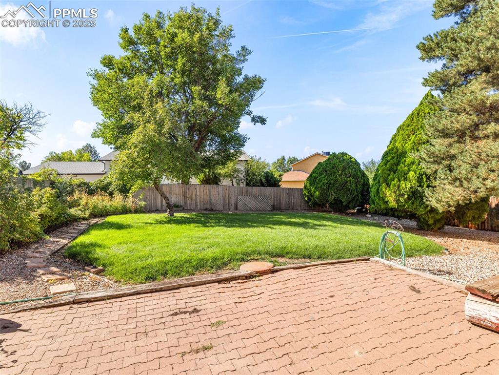 Image 33 of 38: Fenced backyard featuring a patio area
