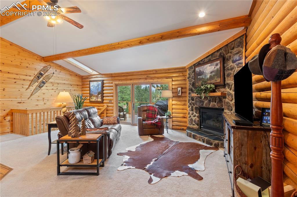 Image 14 of 46: Stone faced gas fireplace keeps you warm on those CO evenings