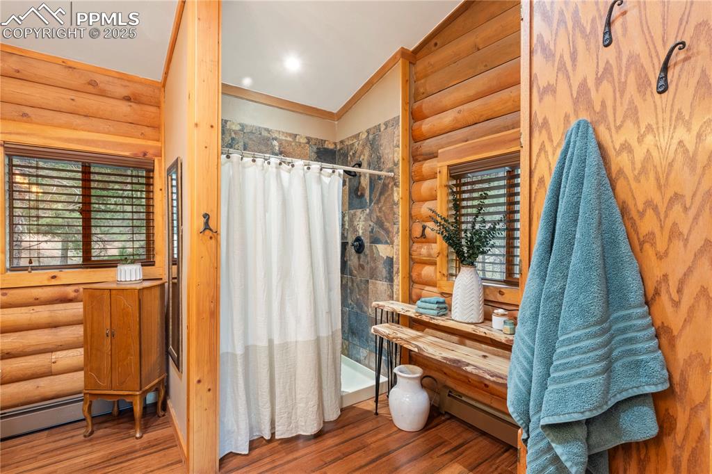 Image 25 of 46: More spa-like features include double shower heads; slate shower walls; lin