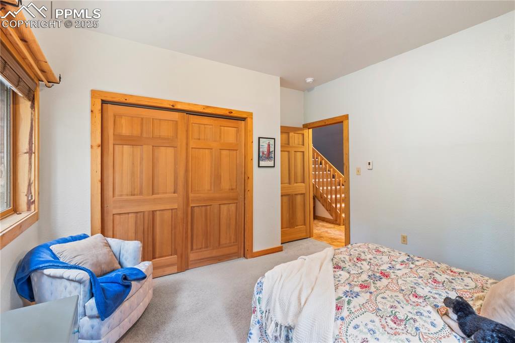 Image 28 of 46: Bedroom #2 lower level has ample closet space w/wood doors