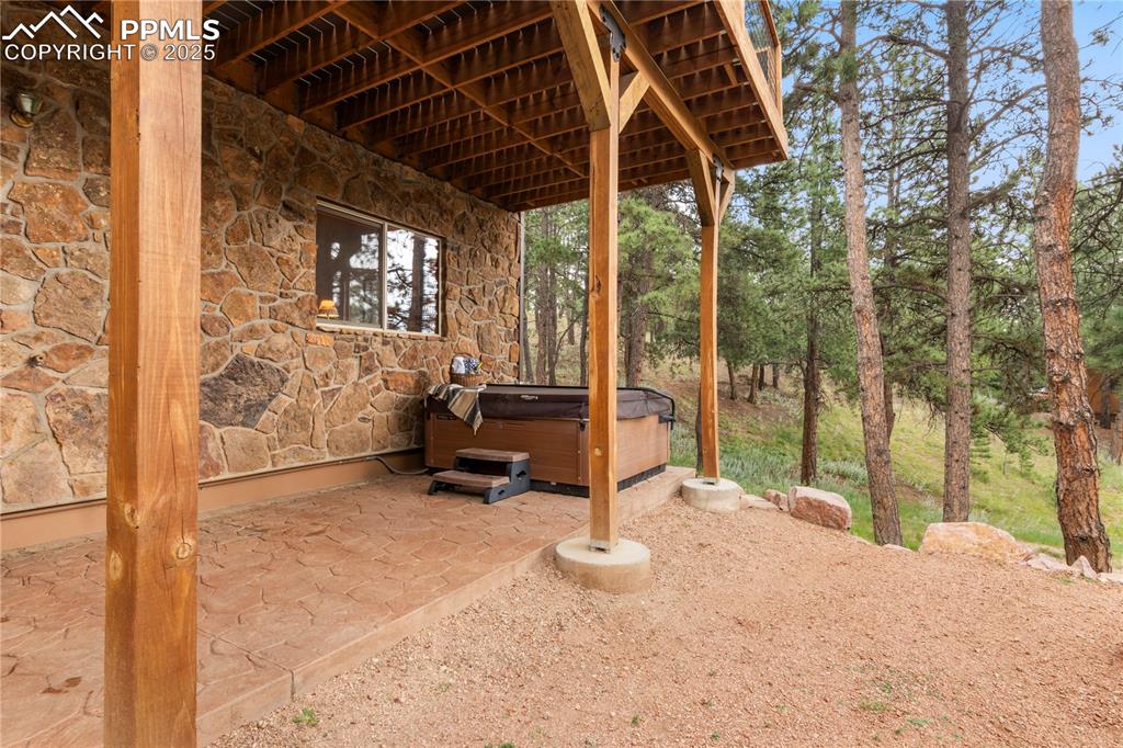 Image 35 of 46: Private covered area on decorative concrete pad - hot tub included