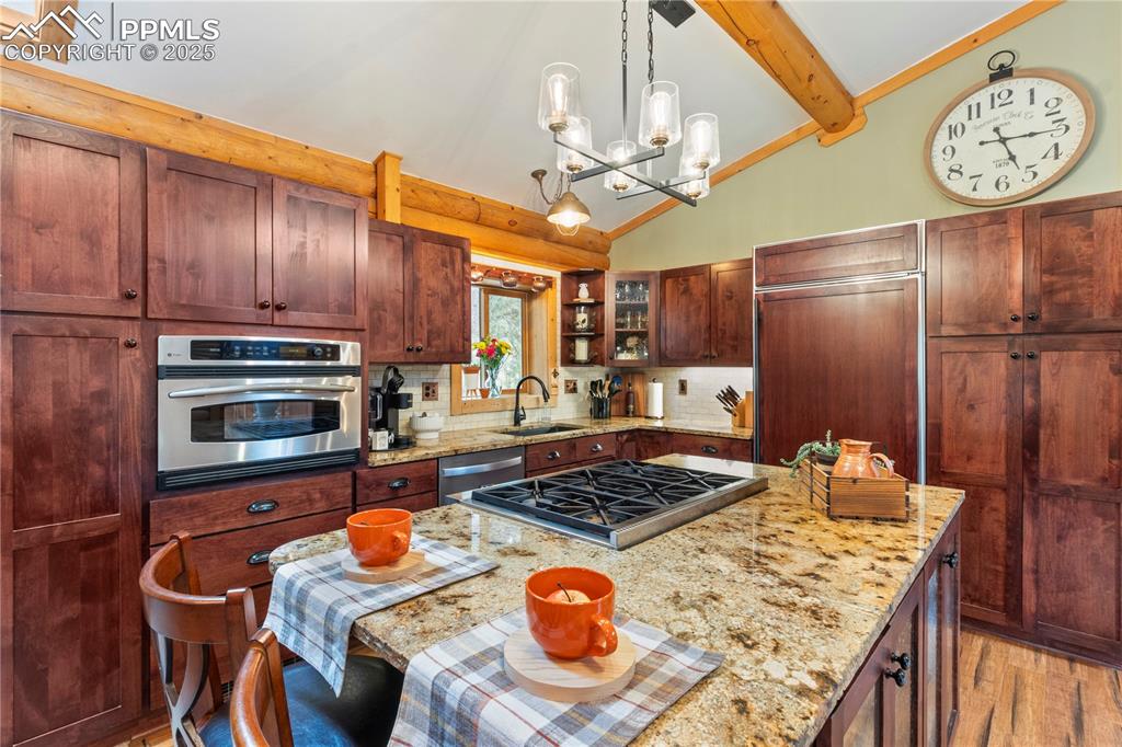 Image 7 of 46: Gourmet kitchen includes granite countertops, subzero fridge, cherry staine
