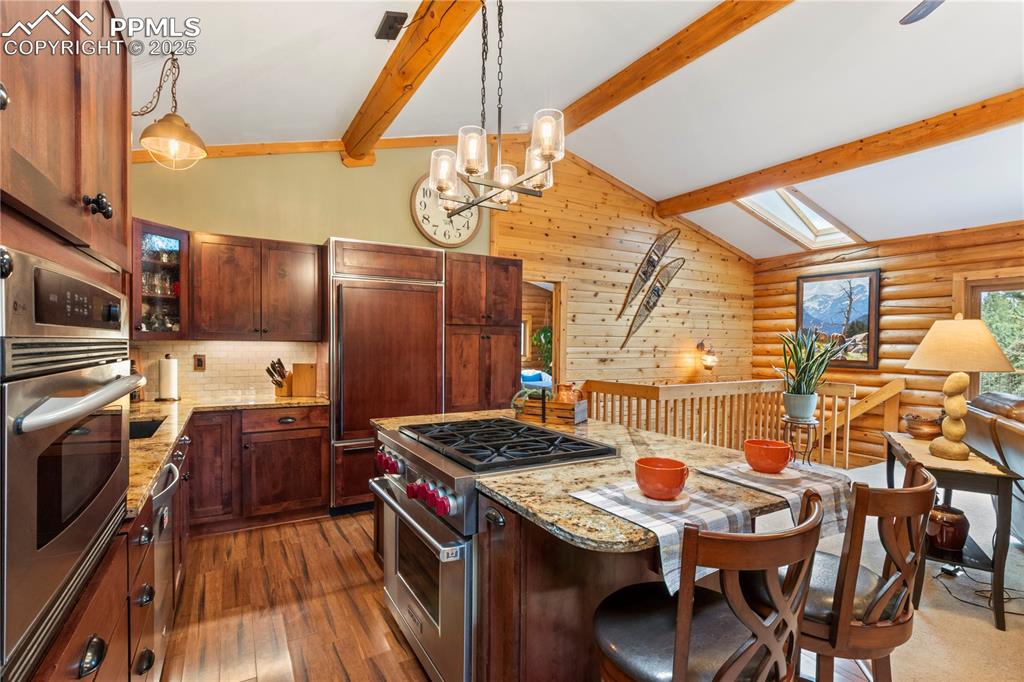 Image 9 of 46: Hardwood floors and beamed ceilings 
