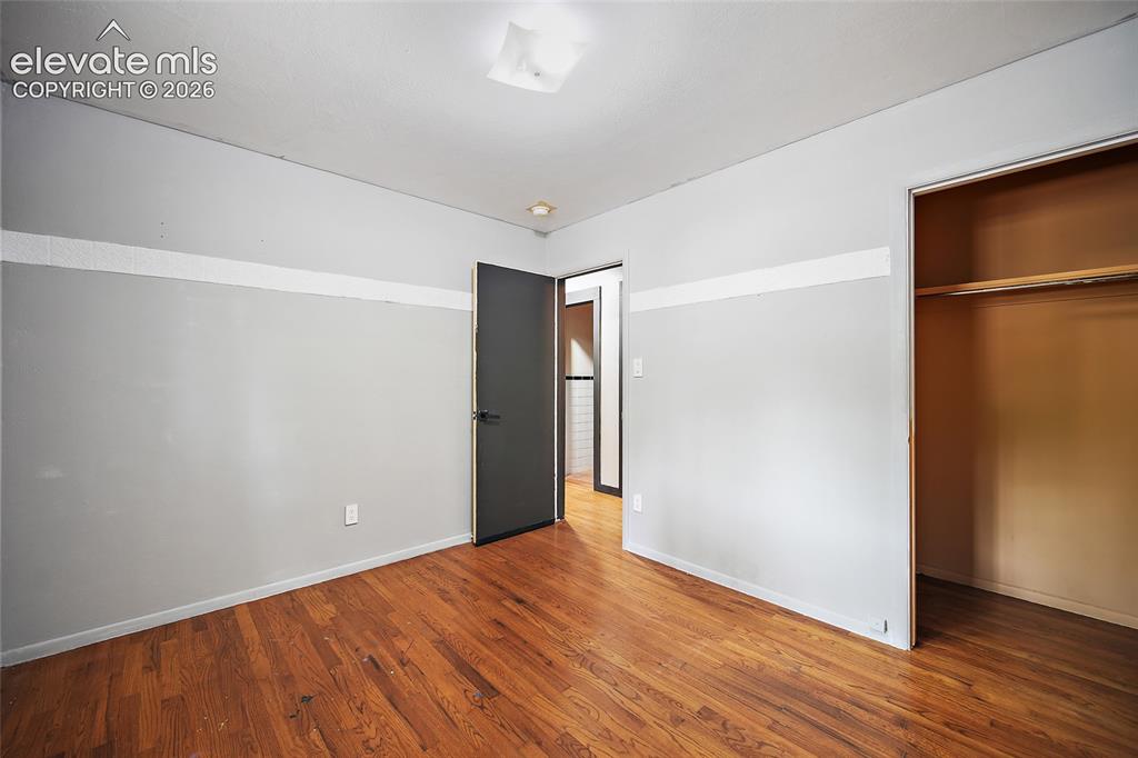 Image 18 of 39: Hardwood flooring throughout, featuring a neutral wall palette, a built-in