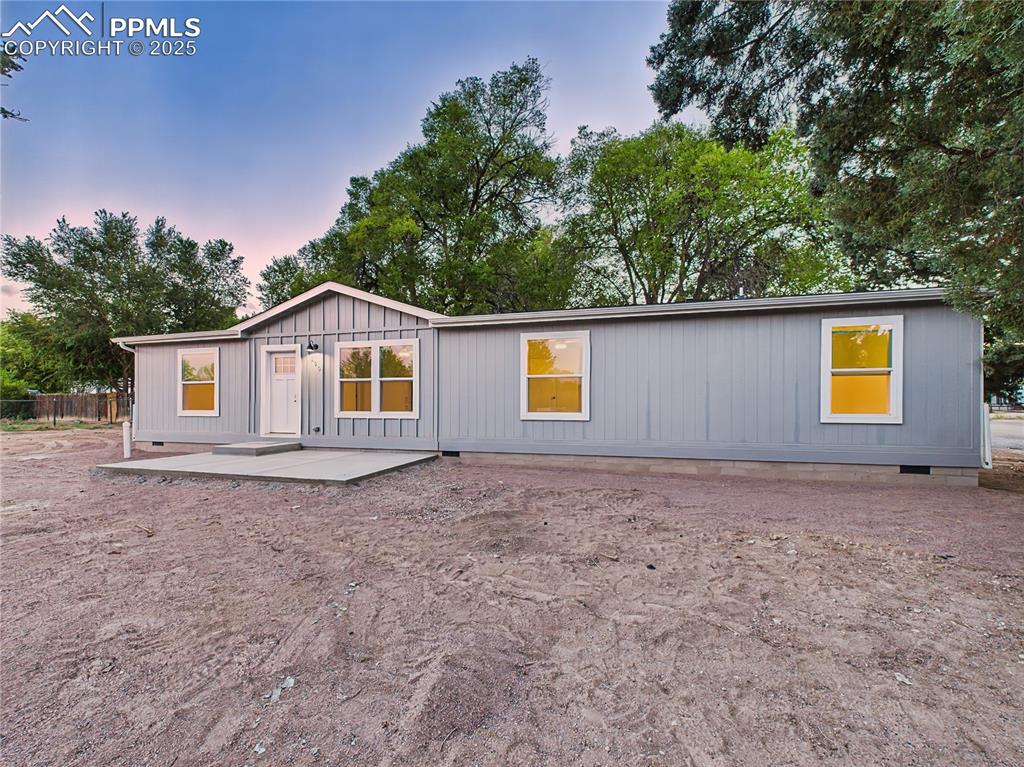 Image 2 of 50: Evening photos highlight curb appeal with warm interior lighting.