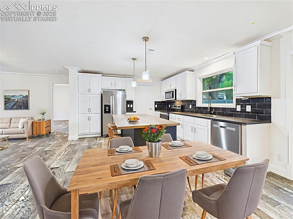 Image 20 of 50: Virtually Staged versions highlight space for casual dining and entertainin