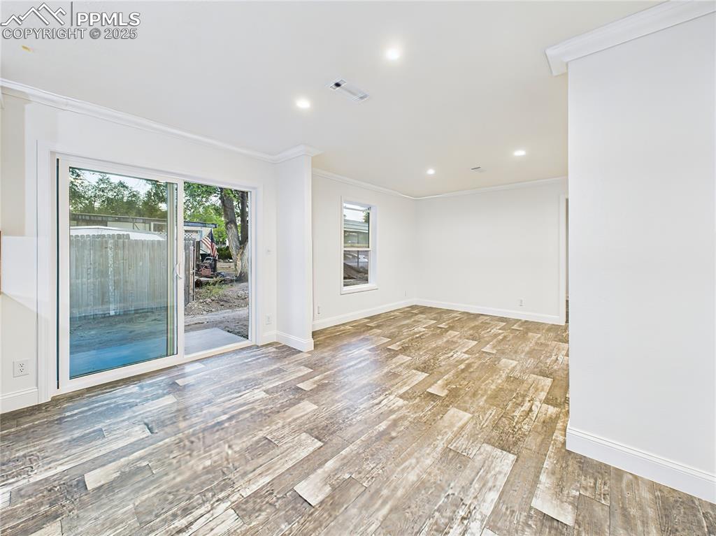 Image 21 of 50: Open dining area with sliding glass doors leading to the back patio.