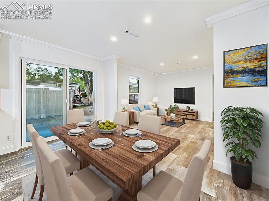 Image 22 of 50: Virtually Staged to demonstrate flow between formal dining and relaxed livi