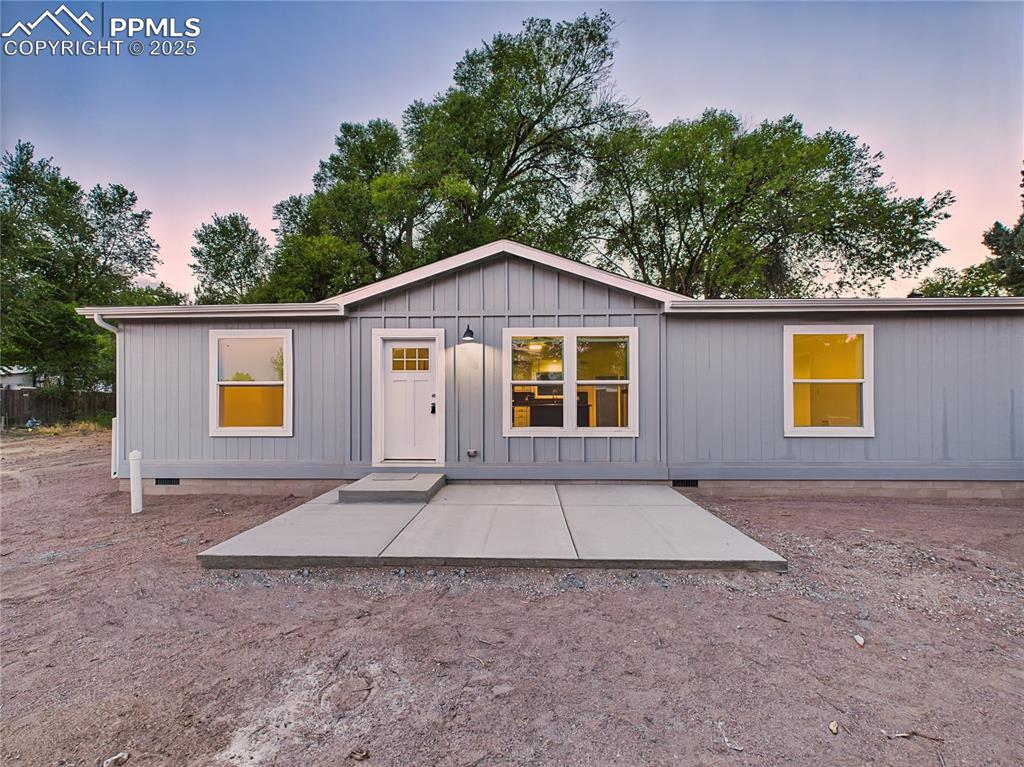 Image 3 of 50: Large front concrete patio provides space for outdoor seating.