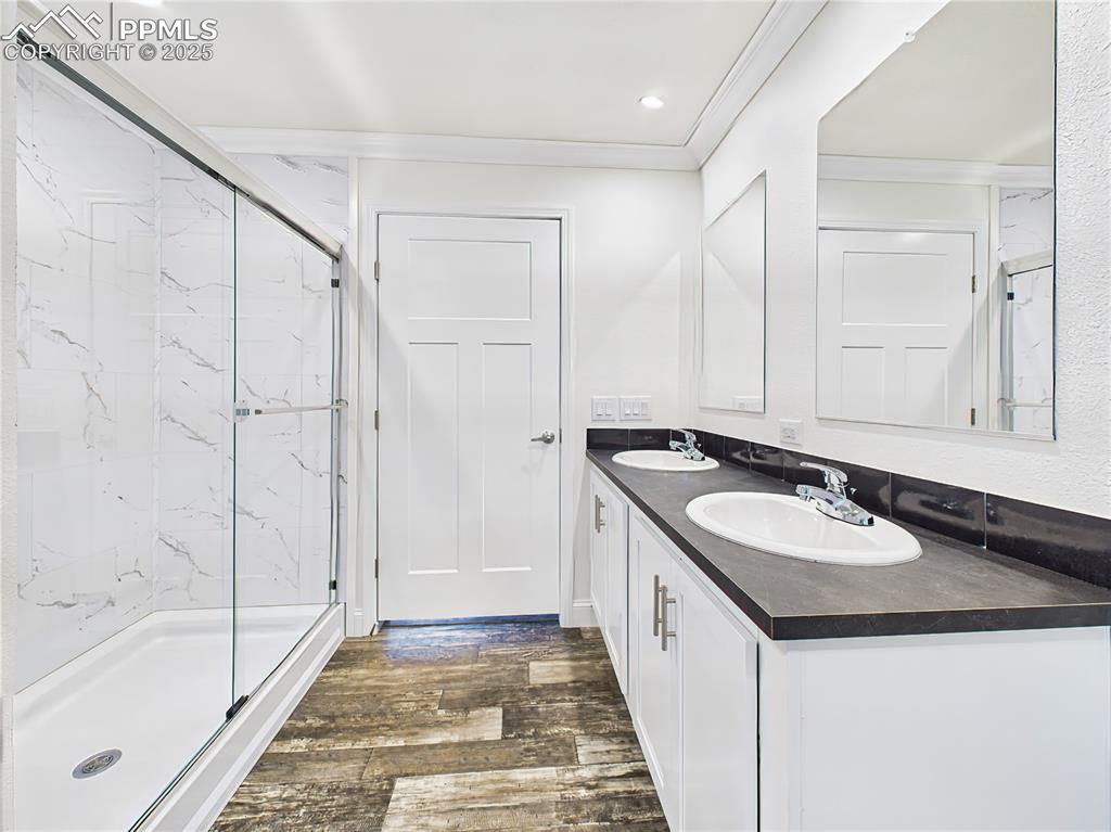 Image 36 of 50: Five-piece ensuite featuring dual vanities with black counters and white ca