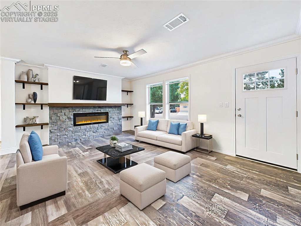 Image 5 of 50: Virtually Staged version highlights space for sofa seating, TV above the fi