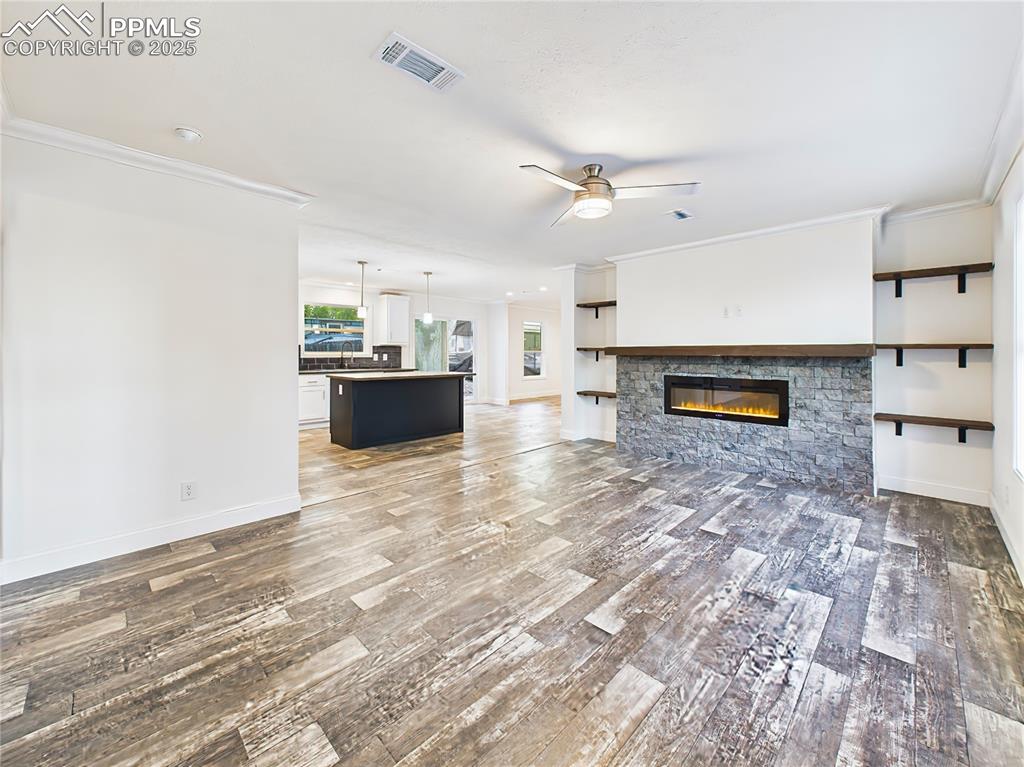Image 6 of 50: Open-concept great room with wide plank luxury vinyl flooring and recessed 