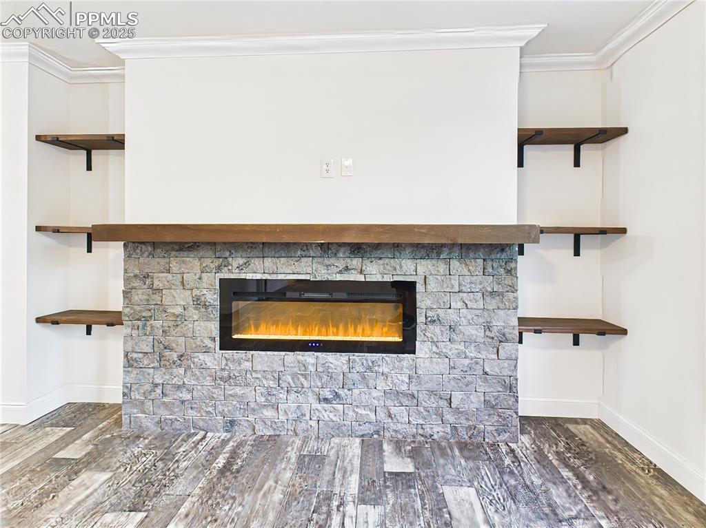 Image 8 of 50: Striking stone accent wall with linear electric fireplace and custom wood s