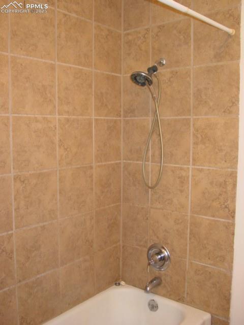 Image 14 of 16: 2002 Full bathroom with bath tub / shower combination and tile surround
