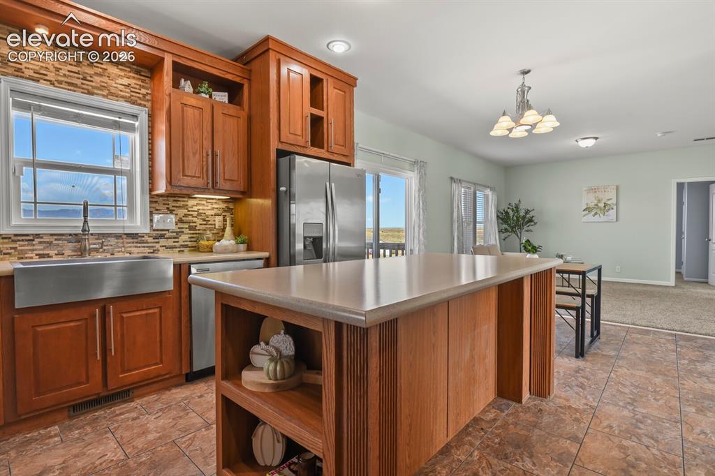 Image 10 of 44: The kitchen has a large farmhouse sink. 