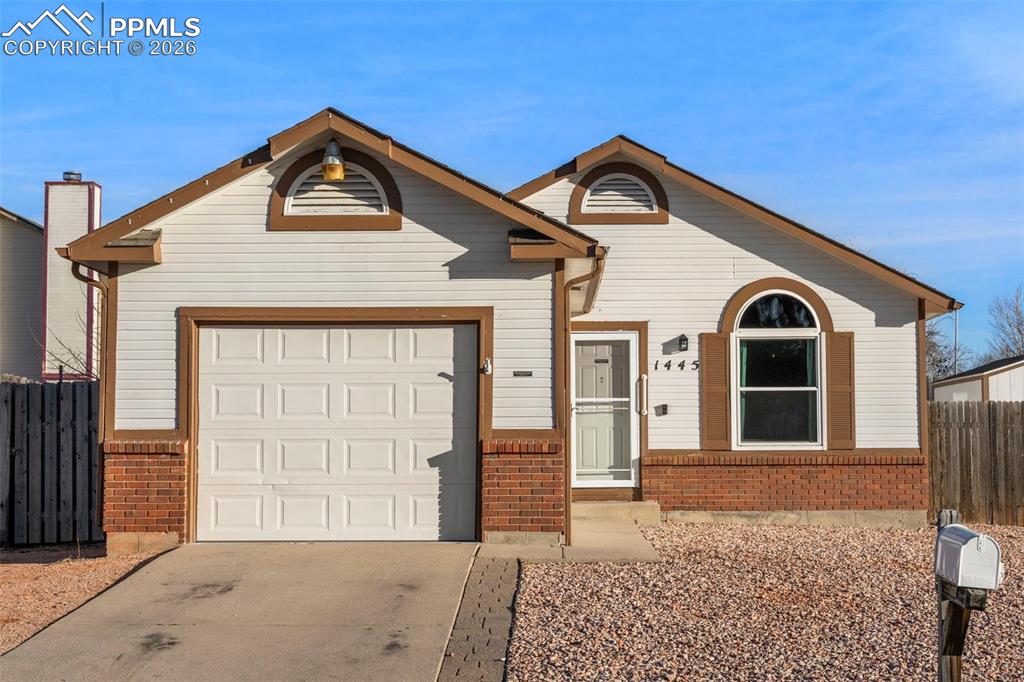 Image 1 of 29: View of front with concrete driveway, brick siding, and an attached garage