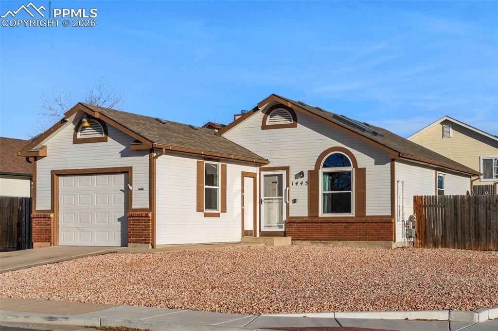 Image 2 of 29: View of front of house with concrete driveway, and a garage