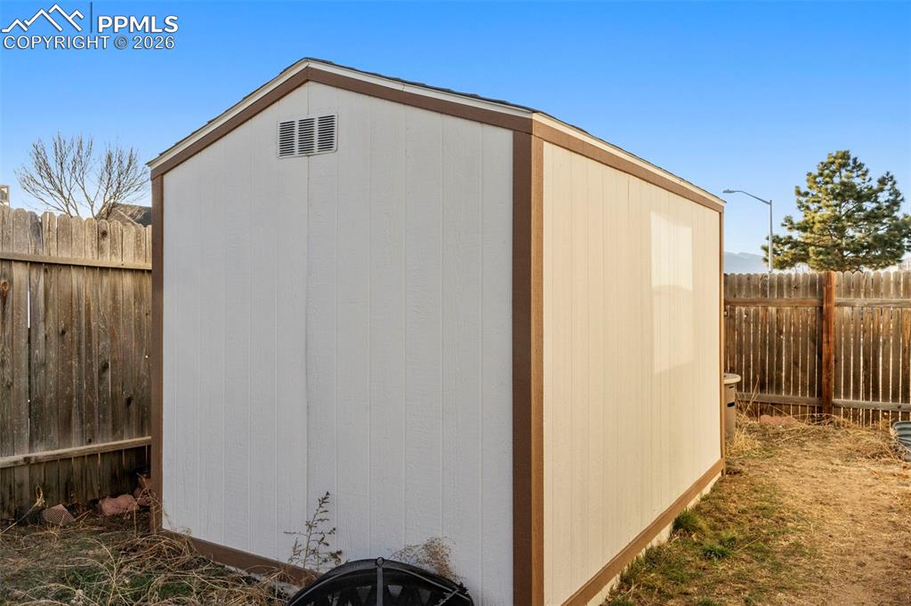 Image 27 of 29: View of shed with a fenced backyard