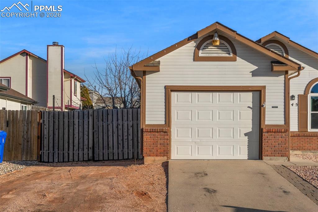 Image 3 of 29: Garage with concrete driveway