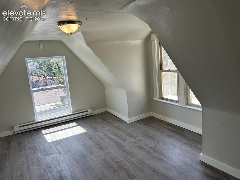 Image 39 of 45: Wood-finish flooring, two windows, baseboard heating, recessed lighting, an