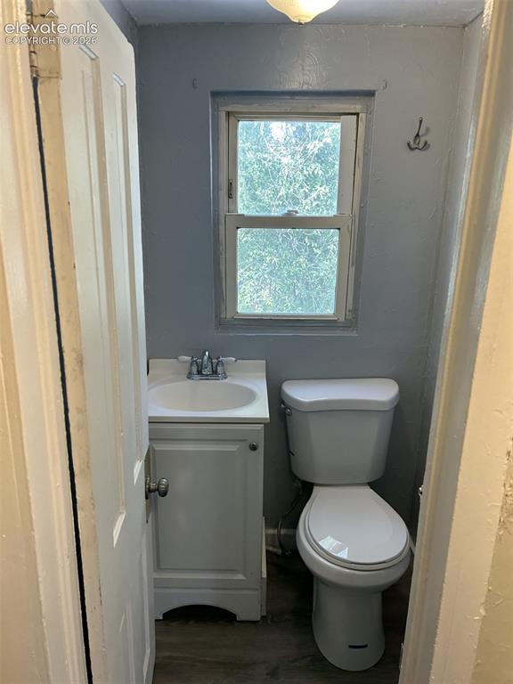 Image 44 of 45: White vanity with integrated sink, chrome faucet, and white toilet