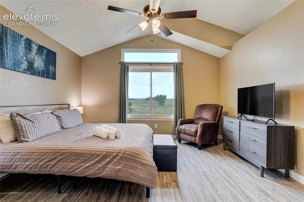 Image 17 of 40: Vaulted ceilings and a ceiling fan create an airy atmosphere